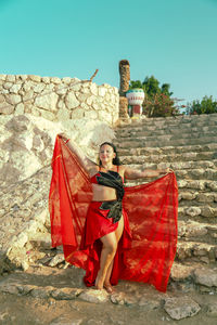 Rear view of woman standing against sky