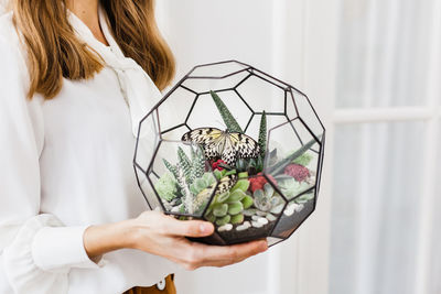 Midsection of woman holding flower bouquet