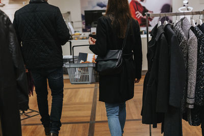 Woman in shop carrying basket