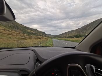 Scenic view of road seen through car windshield