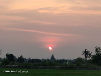 Scenic view of field against sky during sunset