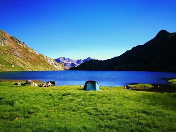 Scenic view of mountains against clear blue sky