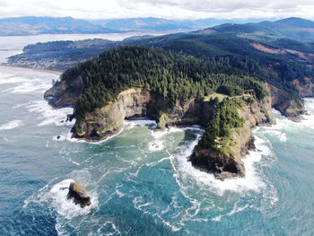 High angle view of sea and mountains against sky