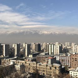 High angle view of modern buildings in city against sky