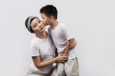 Young couple standing against white background