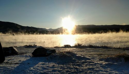 Scenic view of snow covered landscape against sky