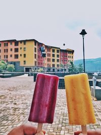 Close-up of ice cream against built structures