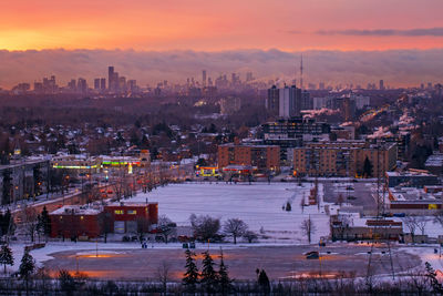 High angle view of buildings in city during sunset