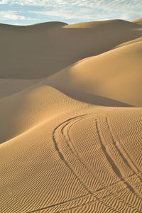 Sand dune in desert against sky