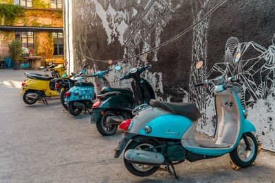 Bicycles parked on street against wall