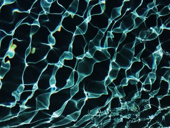 Full frame shot of glowing rippled water in swimming pool