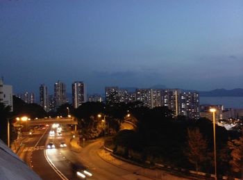 Illuminated cityscape against sky at night