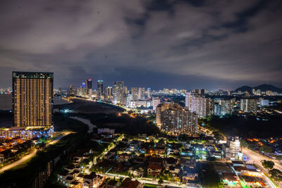 High angle view of illuminated cityscape against sky at night