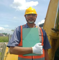 Mid adult man standing against yellow sky