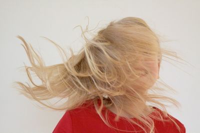 Close-up of woman with hair against white background