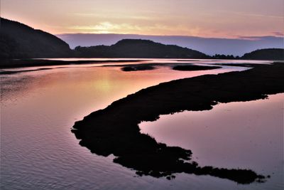 Scenic view of lake against sky during sunset