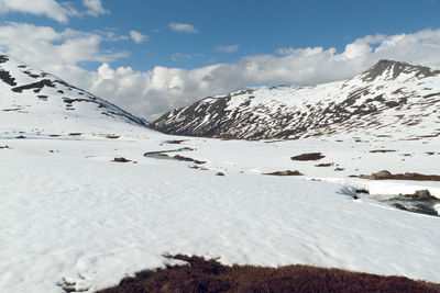 Scenic view of snow covered mountains against sky