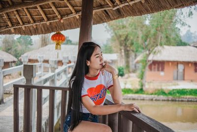 Full length of teenage girl sitting on seat