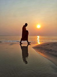 Full length of man on beach during sunset