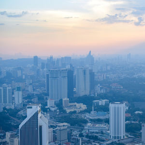 High angle view of modern buildings in city against sky