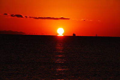 Scenic view of sea against romantic sky at sunset