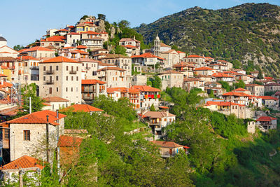 Houses in town against mountains