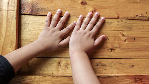Cropped image of hands on wooden table
