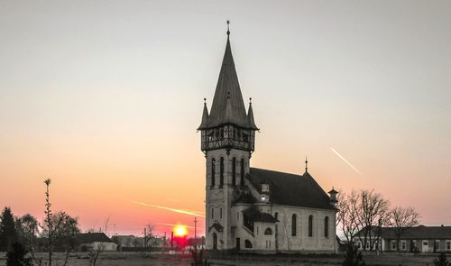 Traditional building against clear sky at sunset