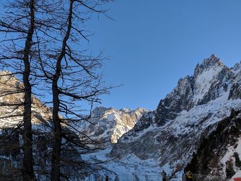 Scenic view of snowcapped mountains against clear blue sky