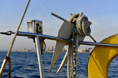 Close-up of sailboat in sea against sky