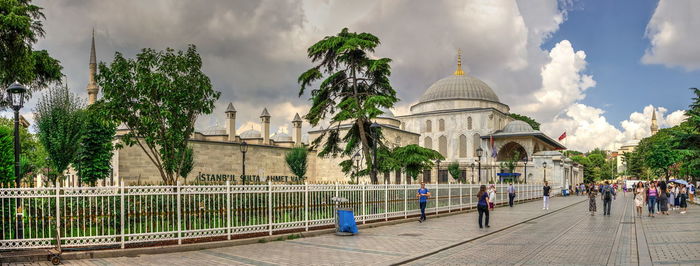 Panoramic view of trees and buildings against sky