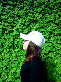 Rear view of woman standing against plants