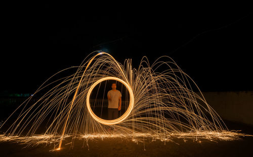 Light trails against sky at night