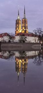 Reflection of building in lake at dusk