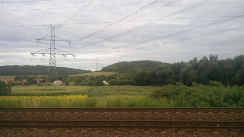 Scenic view of field against cloudy sky