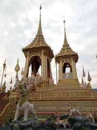 Statue of temple against cloudy sky