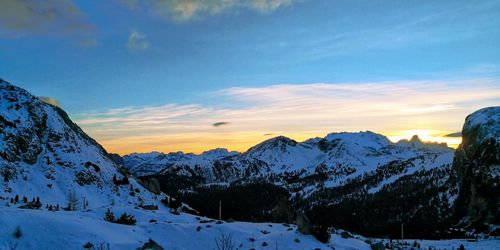 Scenic view of snow covered mountains against sky during sunset