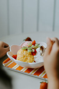 Cropped hand of woman having food