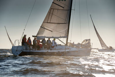 Sailboat sailing on sea against sky