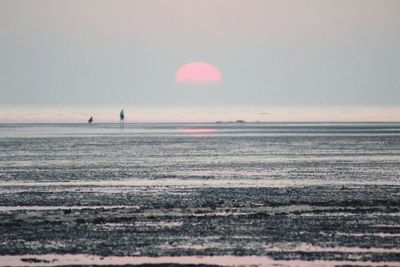 Scenic view of sea against sky at sunset