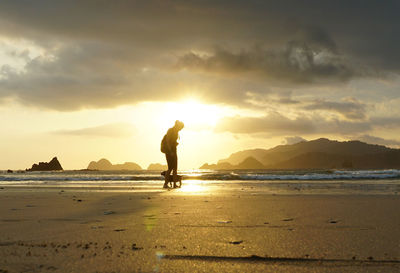 Amazing sunset at pulau merah beach in banyuwangi, east java, indonesia.