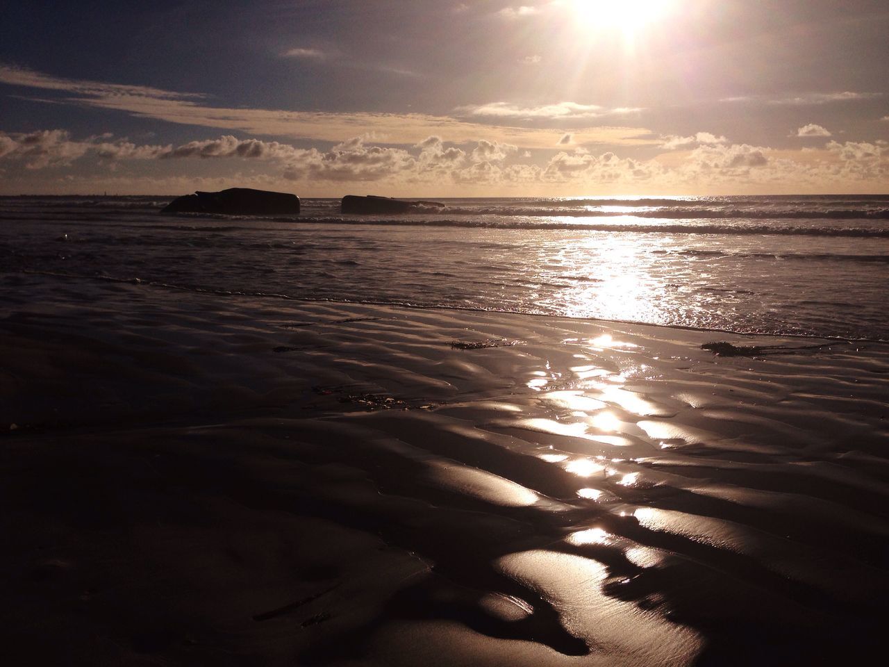 SCENIC VIEW OF BEACH AGAINST SKY AT SUNSET