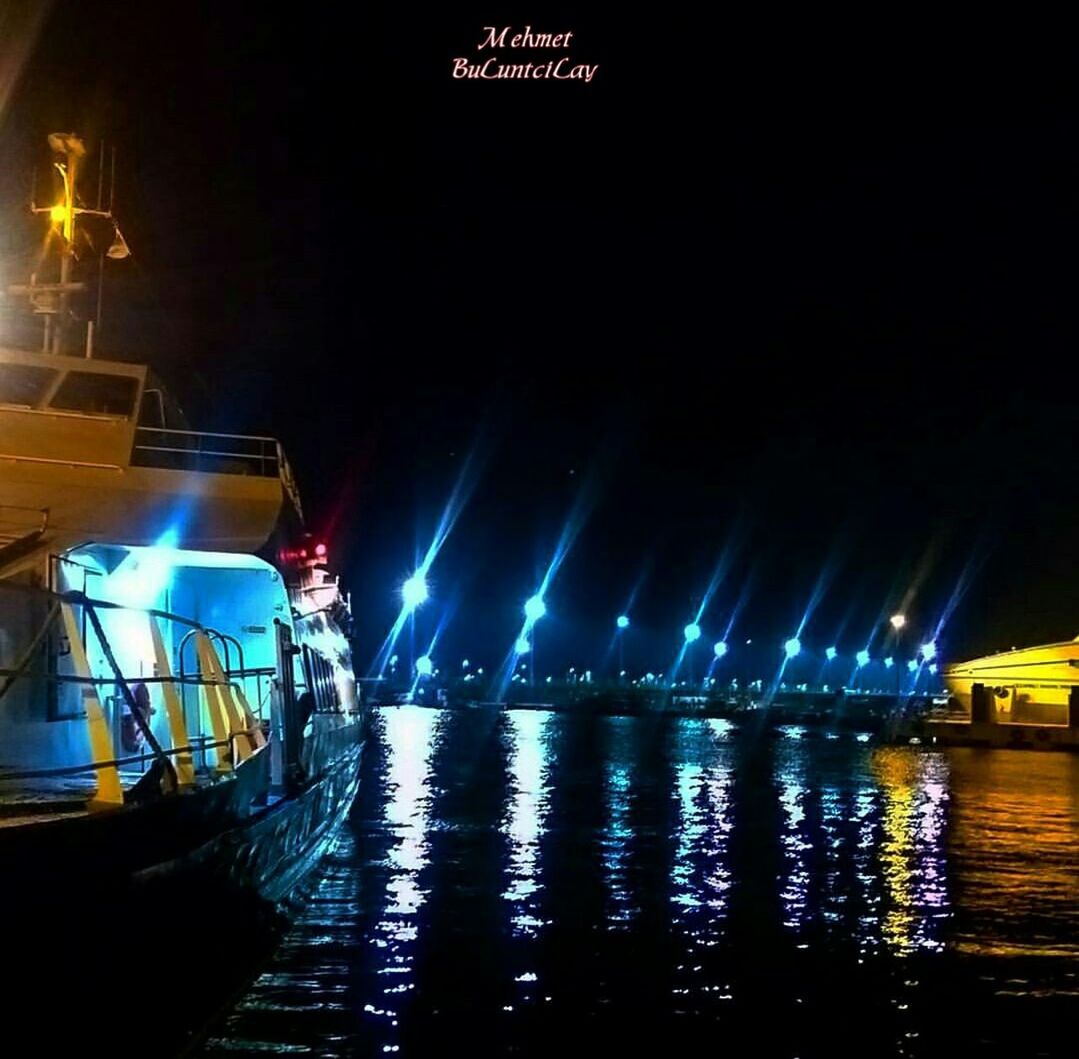 illuminated, night, lighting equipment, street light, built structure, water, building exterior, architecture, transportation, reflection, street, city, motion, light - natural phenomenon, long exposure, mode of transport, incidental people, city life, outdoors