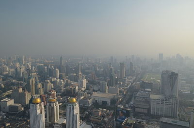 High angle view of buildings in city against clear sky