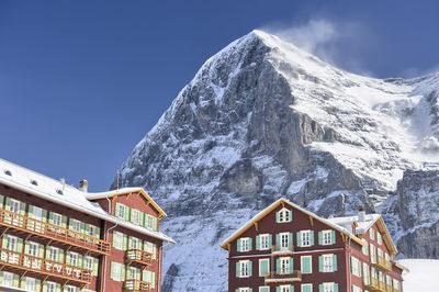 Low angle view of house and mountain against sky