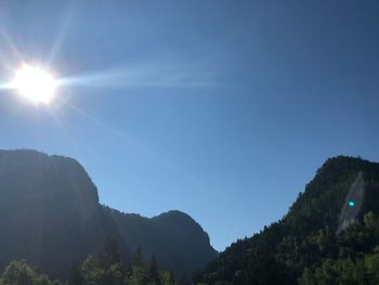 Low angle view of mountains against sky on sunny day