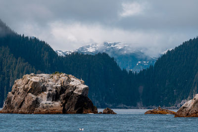Panoramic view of sea and mountains against sky
