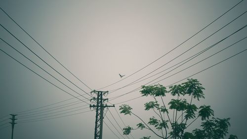 Low angle view of electricity pylon against sky