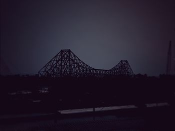 Silhouette illuminated bridge against clear sky at night