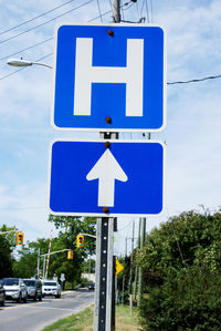Road sign against blue sky